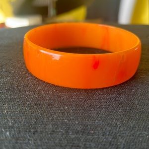 Vintage orange bakelite Bangle. 2 1/2 inches across.
